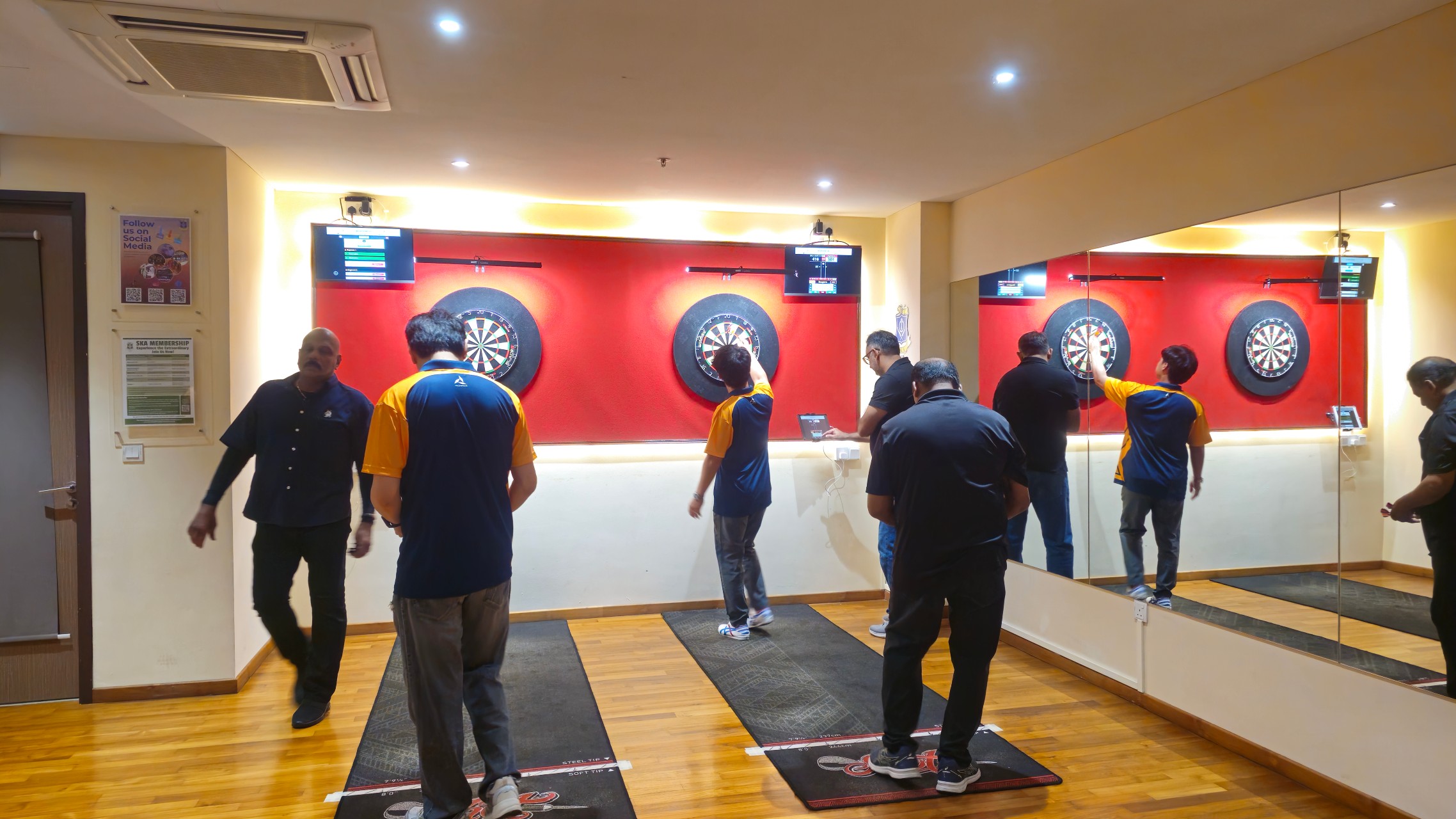 Players competing at the dartboards